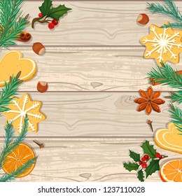 Christmas background. Fir branches, cookies and oranges on a wooden background