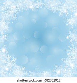 Christmas background with frame of snowflakes in shape of circle in light blue colors and with bokeh effect