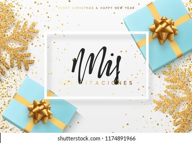 Christmas background with gifts box and shining snowflakes. Spanish text Mis felicitaciones