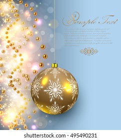 Christmas background glittering lights and shiny gold glass ball