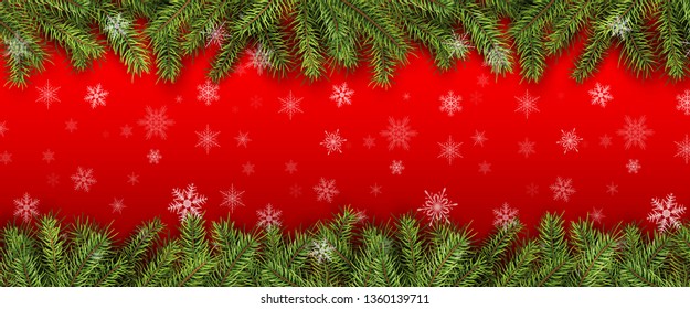 Christmas background green pine tree branches with snowflakes.