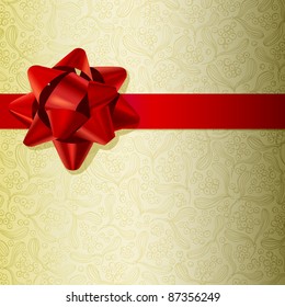 Christmas background made of gold paper with red ribbon