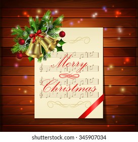 Christmas background with paper ribbon gold bells and lights on a dark wood wall and decorations