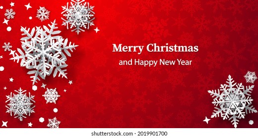 Christmas background of paper snowflakes with soft shadows, white on red background with falling snow
