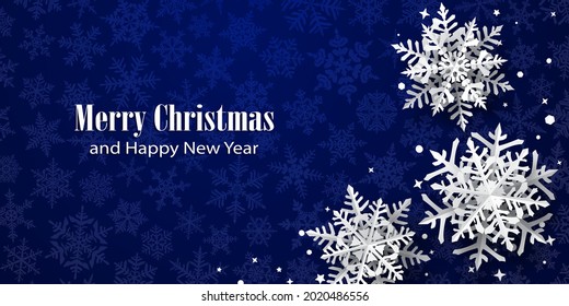 Christmas background of paper snowflakes with soft shadows, white on blue background with falling snow