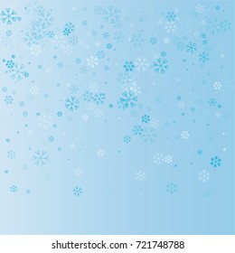 Christmas background with random scatter explosion of falling blue snowflakes on a blue background.