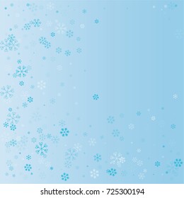 Christmas background with random scatter explosion of falling blue snowflakes on a blue background.