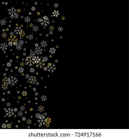 Christmas background with random scatter falling silver and gold snowflakes isolated on black.