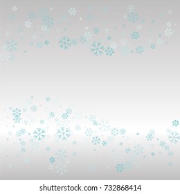 Christmas background with random scatter falling blue snowflakes on a silvery background.