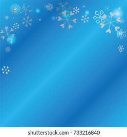Christmas background with random scatter falling silver snowflakes, blue blurred lights and sparkles on a blue background