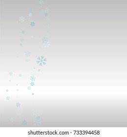 Christmas background with random scatter falling blue snowflakes on a silvery background.
