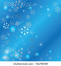 Christmas background with random scatter falling silver snowflakes, blue blurred lights and sparkles on a blue background