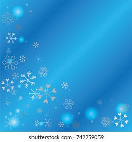 Christmas background with random scatter falling silver snowflakes, blue blurred lights and sparkles on a blue background