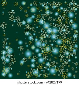 Christmas background with random scatter falling golden snowflakes and blue blurred lights on a dark green background.
