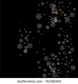 Christmas background with random scatter falling silver and gold snowflakes isolated on black.