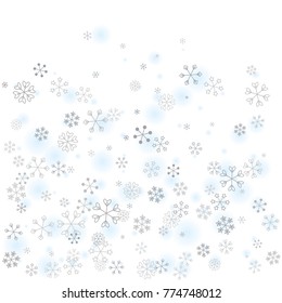 Christmas background with random scatter falling silver snowflakes and blue blurred dots isolated on white.