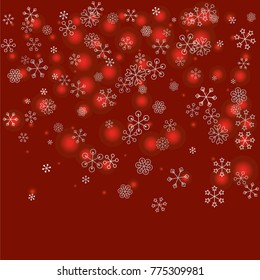 Christmas background with random scatter falling silver snowflakes and red blurred lights on a burgundy background.