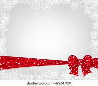 Christmas background. Red bow on gray winter background with snowflake frame.