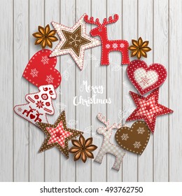 Christmas background, small scandinavian styled red decorations lying on white wooden desk, inspired by flat lay style, with text Merry christmas, framed by abstract leaf wreath, vector illustration