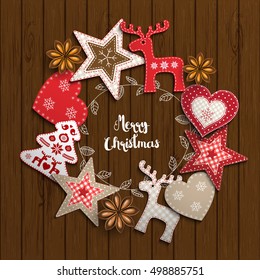 Christmas background, small scandinavian styled red decorations lying on brown wooden desk, inspired by flat lay style, with text Merry christmas, framed by abstract leaf wreath, vector illustration