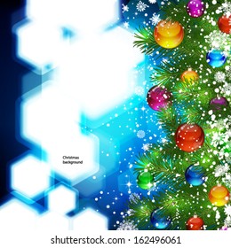 Christmas background with snow-covered Christmas tree decorated with glass balloons