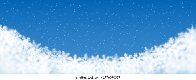 Weihnachtshintergrund aus Schneeflocken verschiedener Form, unscharf und transparent, unten auf hellblauem Hintergrund