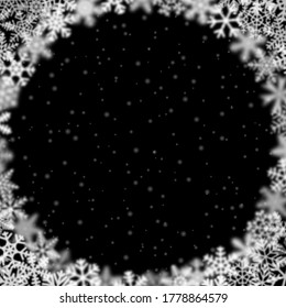 Christmas background of snowflakes of different shape, blur and transparency, arranged in a circle, on black background