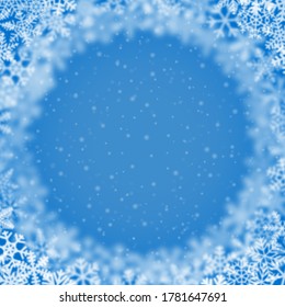 Christmas background of snowflakes of different shape, blur and transparency, arranged in a circle, on light blue background