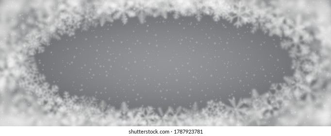 Christmas background of snowflakes of different shape, blur and transparency, arranged in a ellipse, on gray background