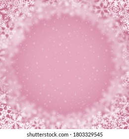 Christmas background of snowflakes of different shape, blur and transparency, arranged in a circle, on pink background