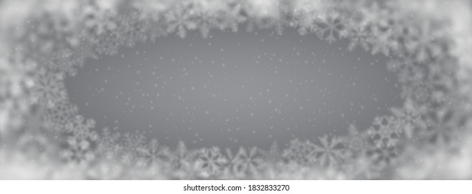 Fondo navideño de copos de nieve de diferente forma, borrosidad y transparencia, dispuestos en una elipse, sobre fondo gris