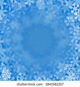 Christmas background of snowflakes of different shape, blur and transparency, arranged in a circle, on light blue background