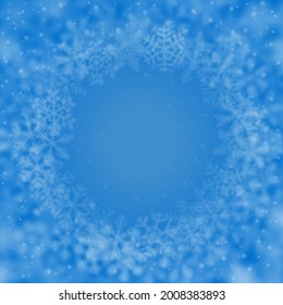 Christmas background of snowflakes of different shape, blur and transparency, arranged in a circle, on light blue background
