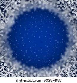 Christmas background of snowflakes of different shape, blur and transparency, arranged in a circle, on blue background