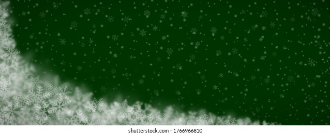 Christmas background of snowflakes of different shapes, sizes, blur and transparency on green background