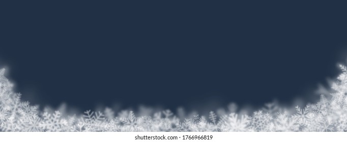 Christmas background of snowflakes of different shapes, sizes, blur and transparency on dark blue background