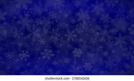 Christmas background of snowflakes of different shapes, sizes, blur and transparency in blue colors