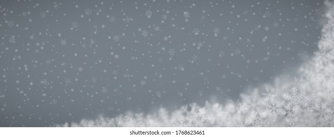 Fondo navideño de copos de nieve de diferentes formas, tamaños, borrosidad y transparencia en fondo gris