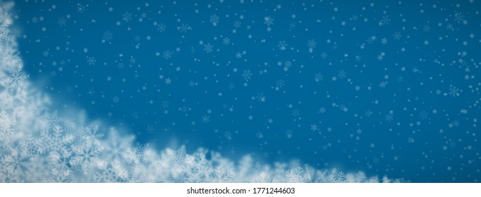 Christmas background of snowflakes of different shapes, sizes, blur and transparency on blue background