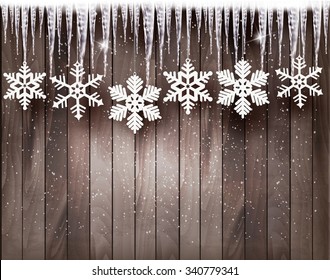 Christmas background with snowflakes and icicles in front of a wooden wall. Vector.