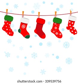 Christmas background with snowflakes and socks hanging on a rope