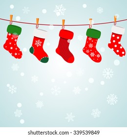 Christmas background with snowflakes and socks hanging on a rope