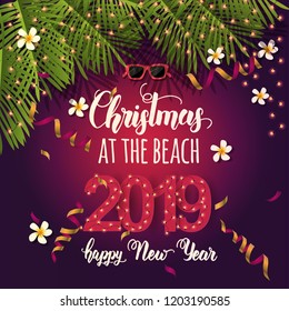 Christmas background with summer tropical symbols, serpentine and hand written quote "Christmas at the beach. Happy New Year 2019". Banner,poster, flyer, brochure