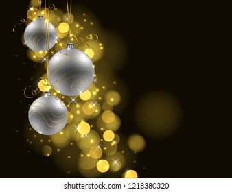 Christmas background. Three silver baubles on dark background with golden lights and space for text. 
