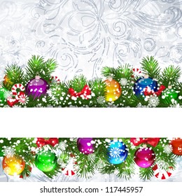 Christmas background with Christmas tree branches decorated with glass balls.