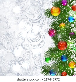 Christmas background with Christmas tree branches decorated with glass balls.