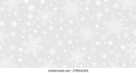 Christmas background of various complex big and small snowflakes, white on gray