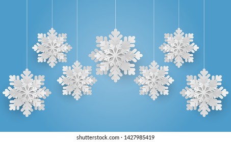 Christmas background with white snowflake on blue background. Paper cut style