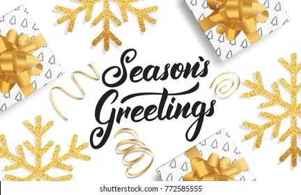 Christmas. Background for winter seasonal holidays. Gold glitter snowflakes, gift boxes and Lettering Season's Greetings