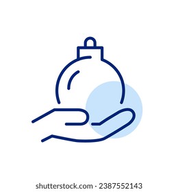 Christmas ball in hand. Winter holidays celebration. Pixel perfect icon